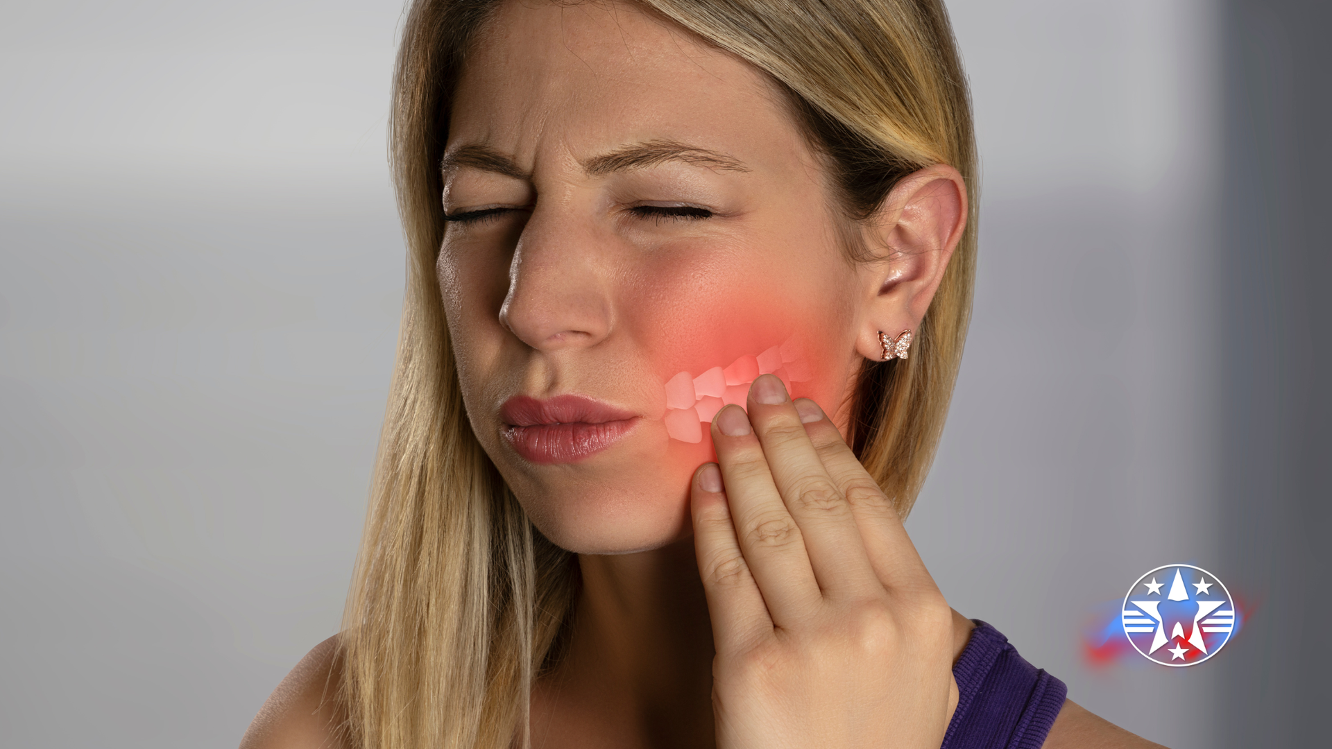 Woman holding jaw, indicating pain. Red highlight on cheek.