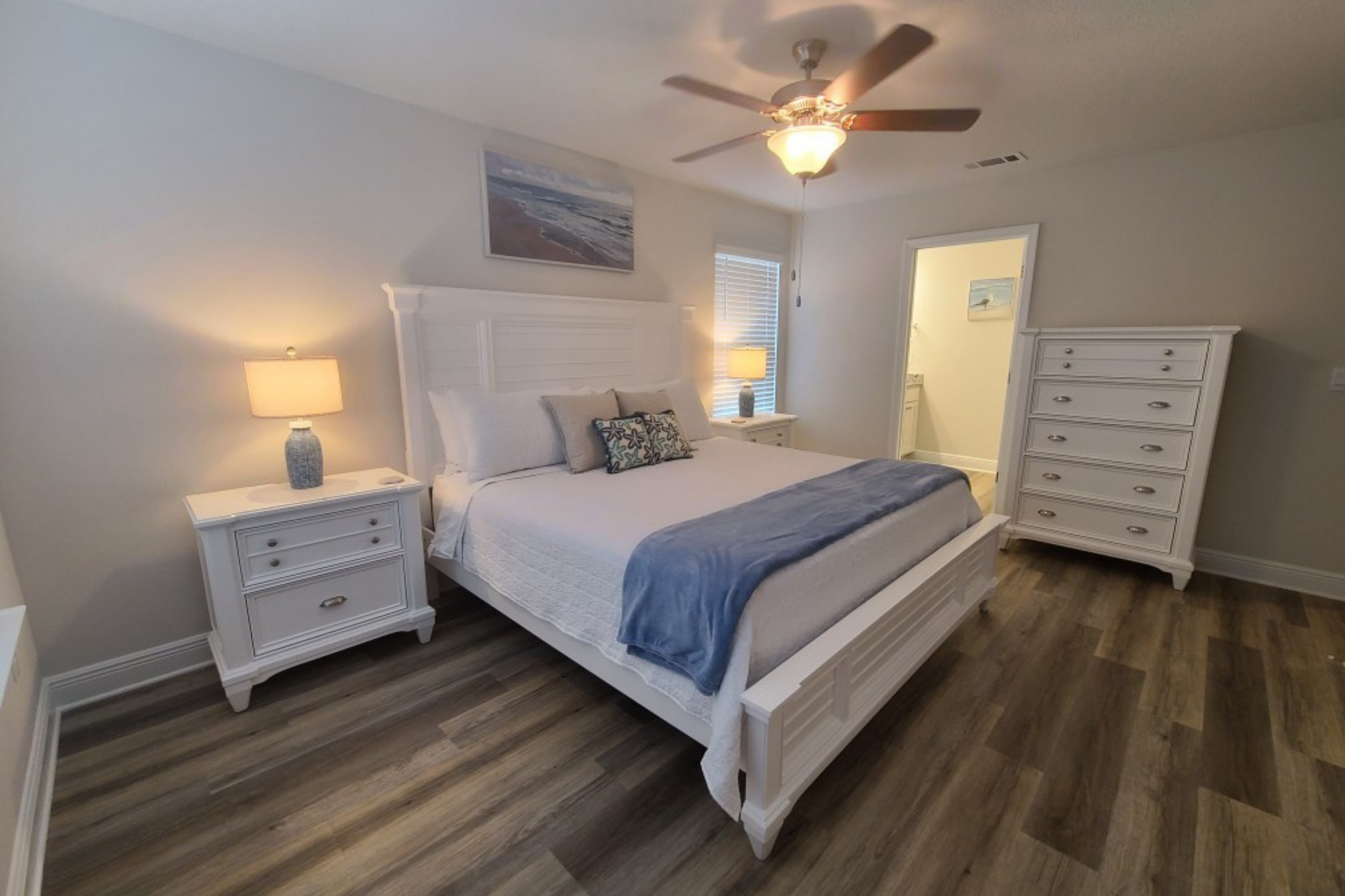 Primary bedroom with king bed and coastal decor at a Panama City Beach vacation rental
