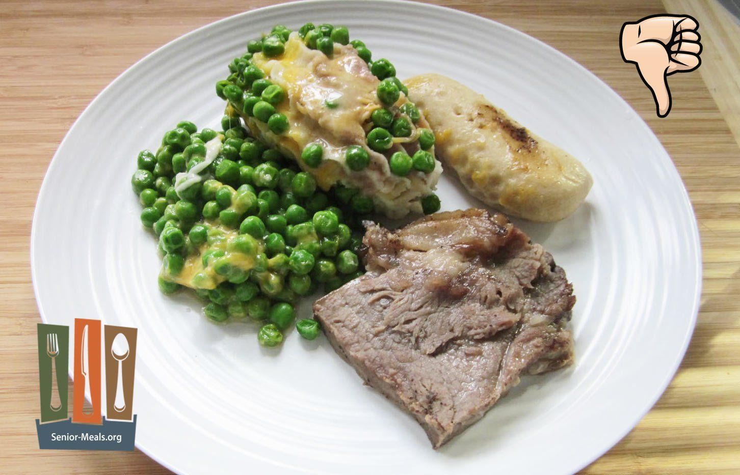 Beef Strip Loin Steak - The Small Portion of Beef was Tough, Dry, and Fatty. The Peas and Potatoes were all Mushed Together Because of Single Compartment Tray, and the Roll didn't Reheat Well.