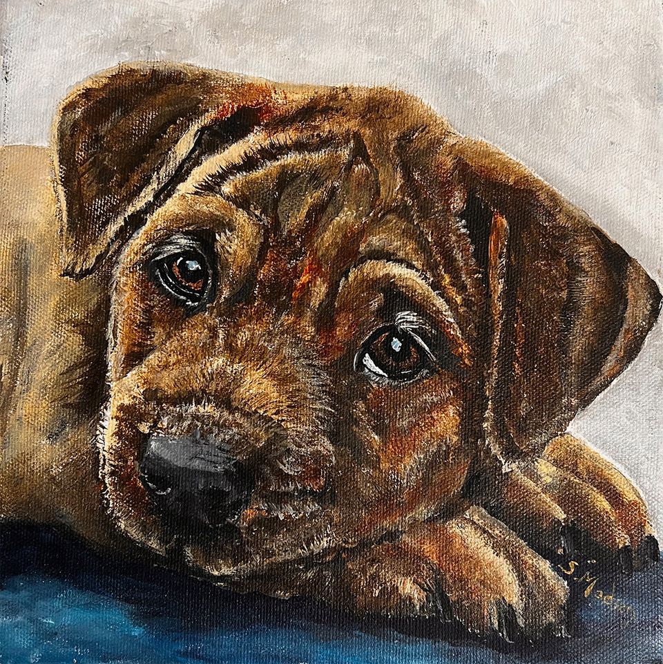 A close up of a painting of a puppy laying down on a table.