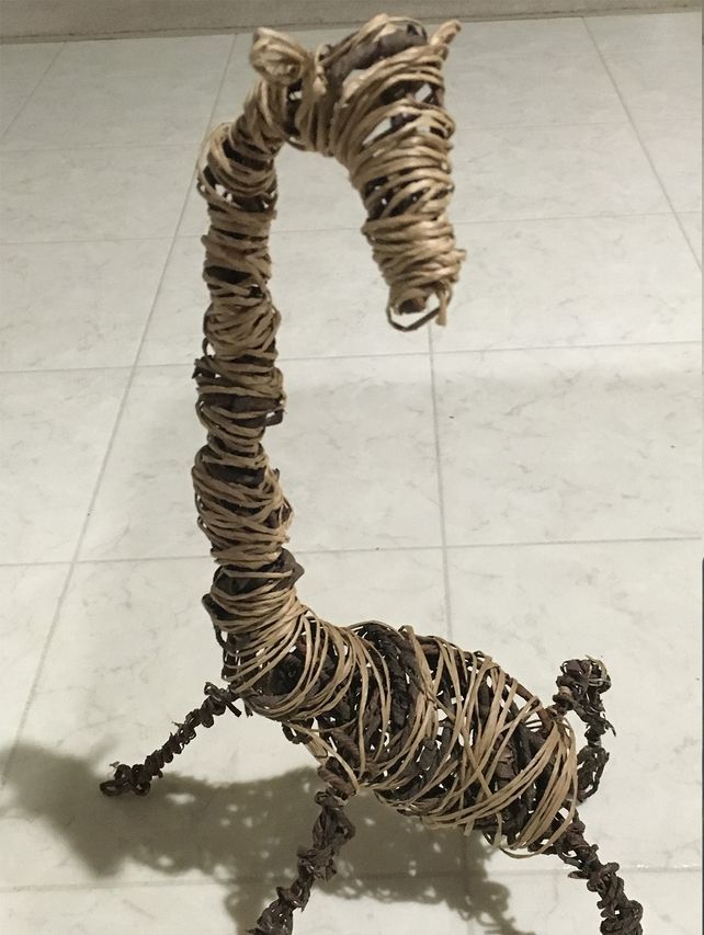 A sculpture of a giraffe made of rope and wire