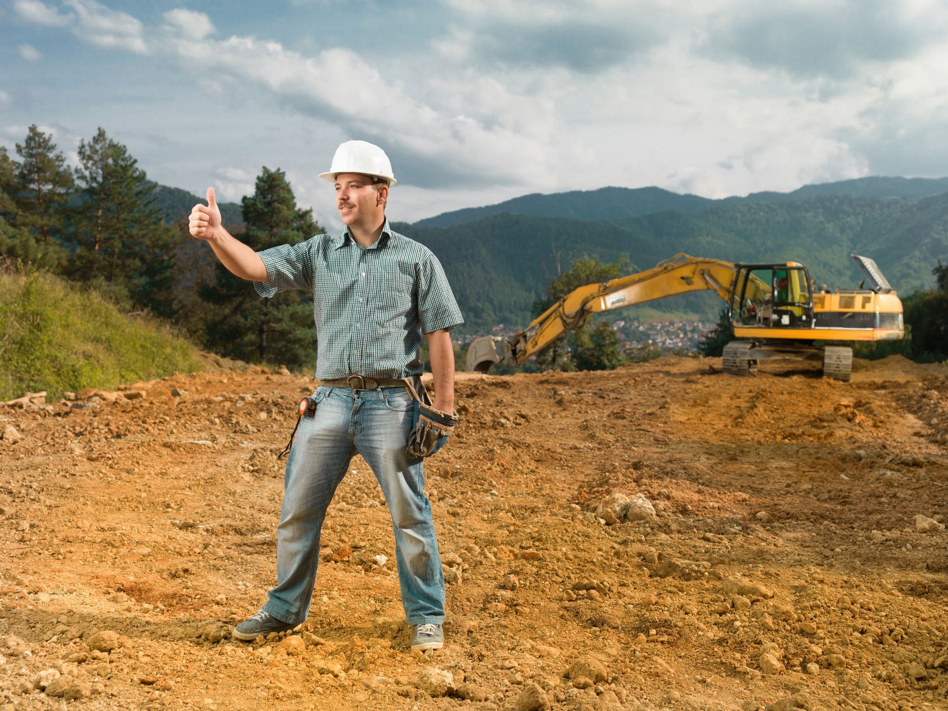 Male engineer showing ok sign on construction site.