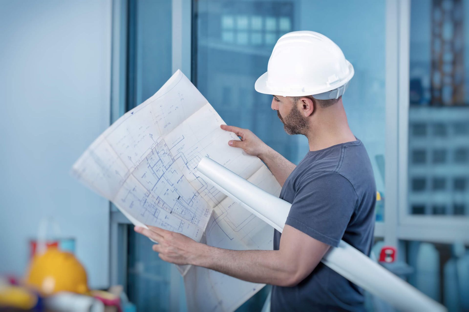 An architect builder studying layout plan of the rooms.