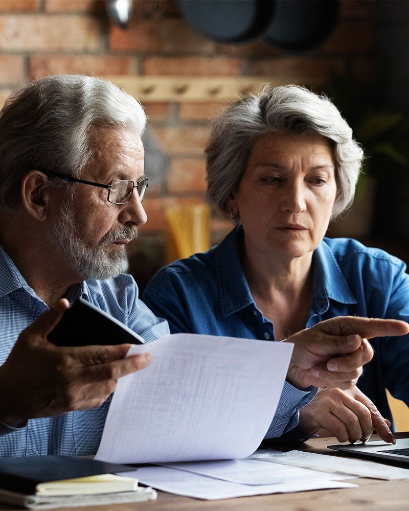 Senior couple looking at utility bills online