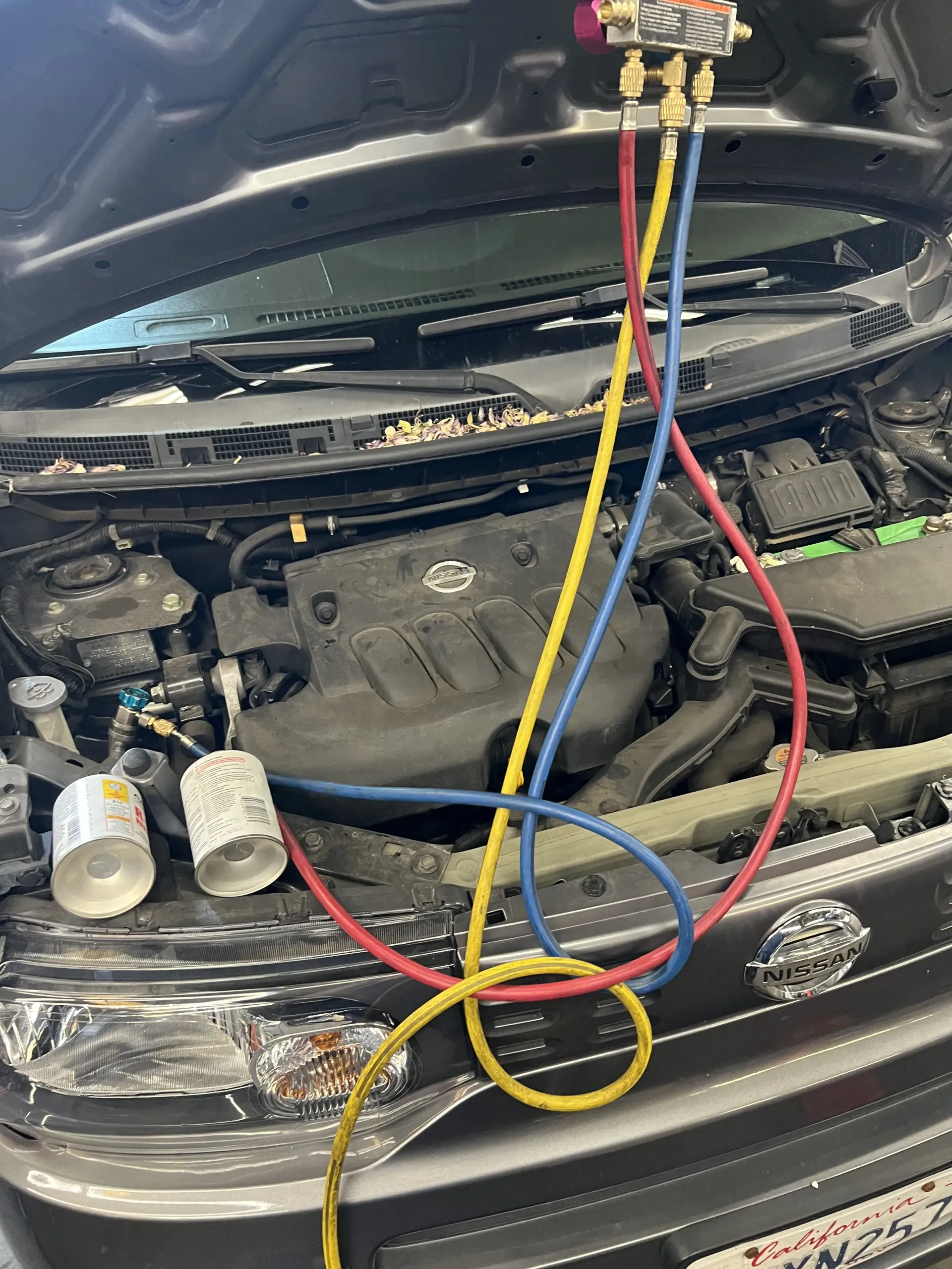 A car with an open hood showing its engine