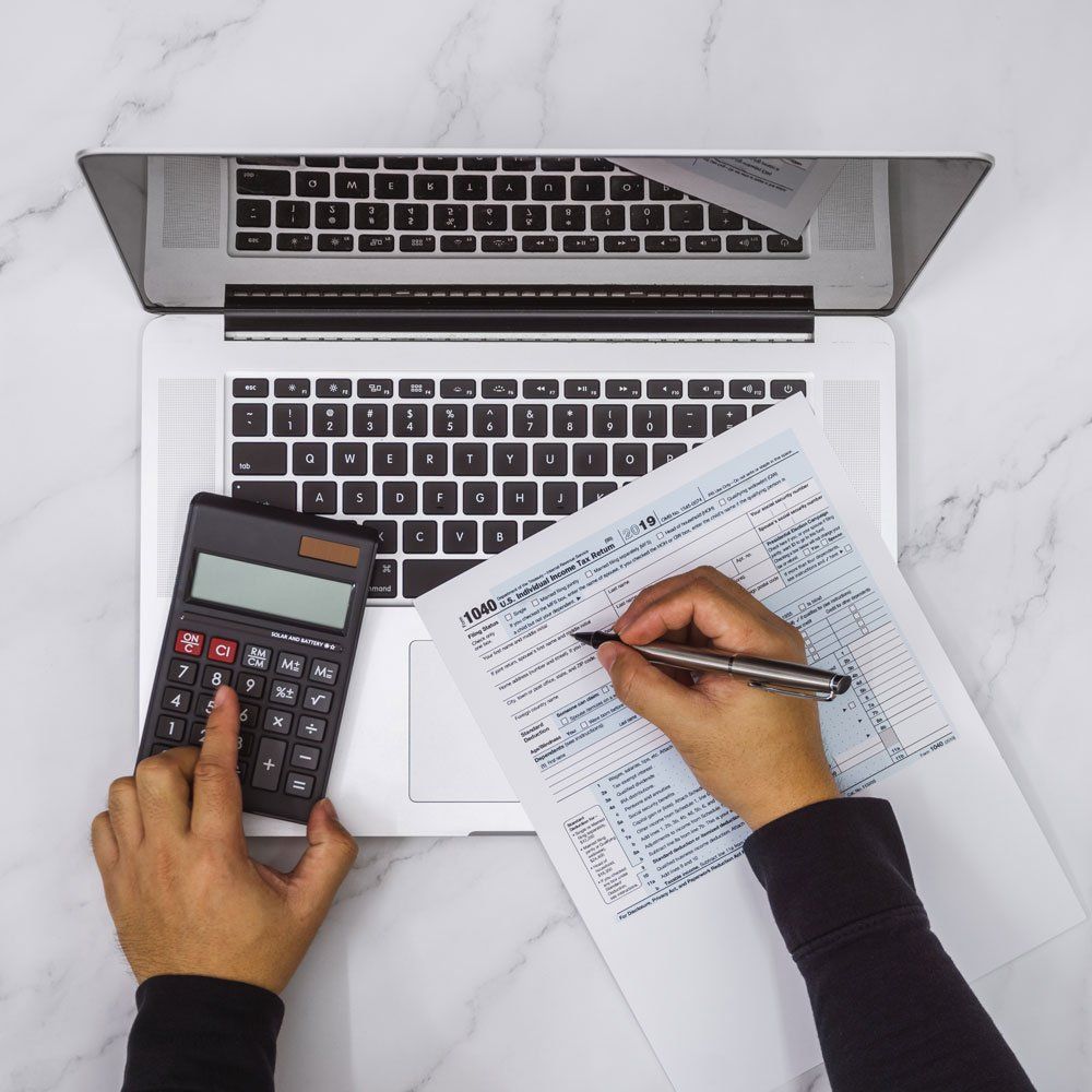 Laptop, Calculator and Form 1040 — Yorkville, IL — Dain Conway’s Tax Service