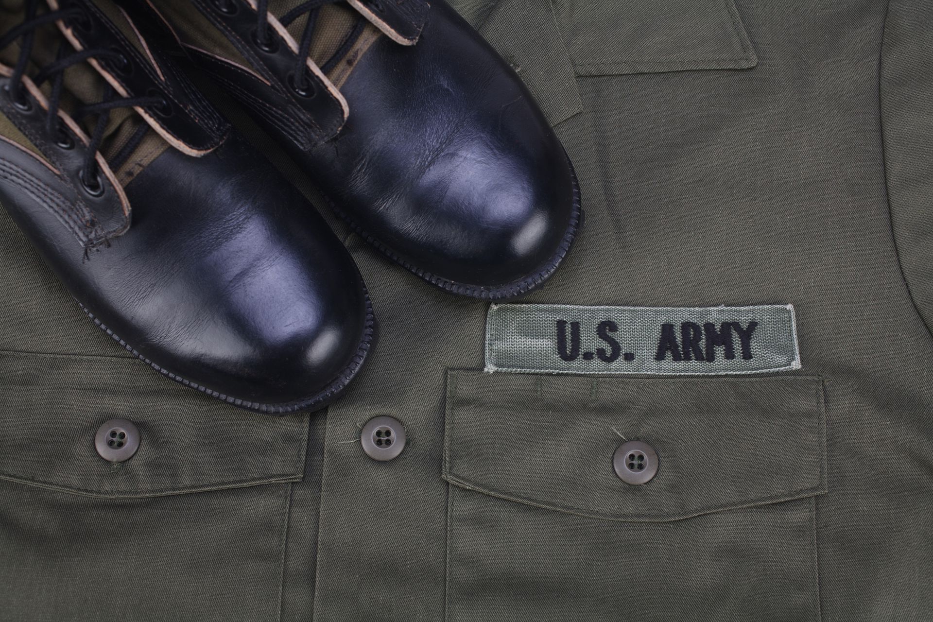 A Pair Of Black Boots Are Sitting On Top Of A US Army Uniform | Clarksville, TN | Snyder’s Tailoring