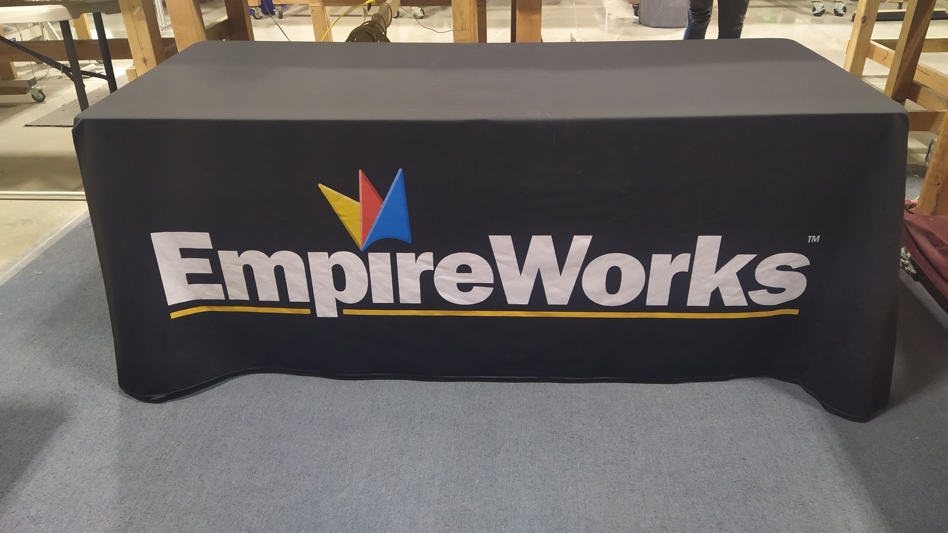 A black table cloth with the empireworks logo on it