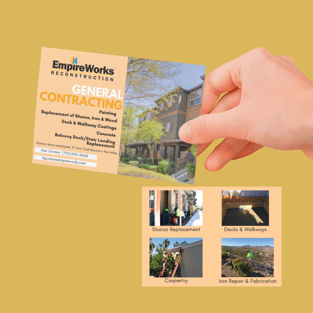 A hand is holding a business card for empire works general contracting