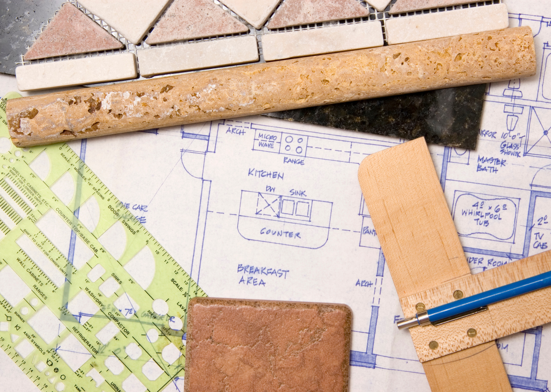 Kitchen design plan with tile samples, ruler, and other tools.