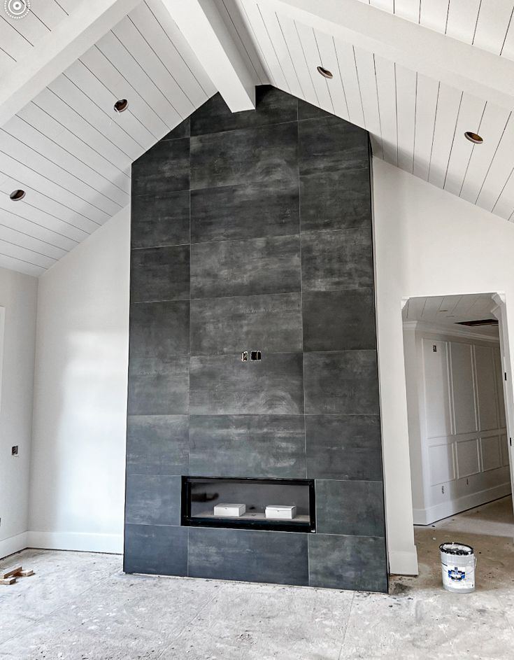 A fireplace in a room with a vaulted ceiling