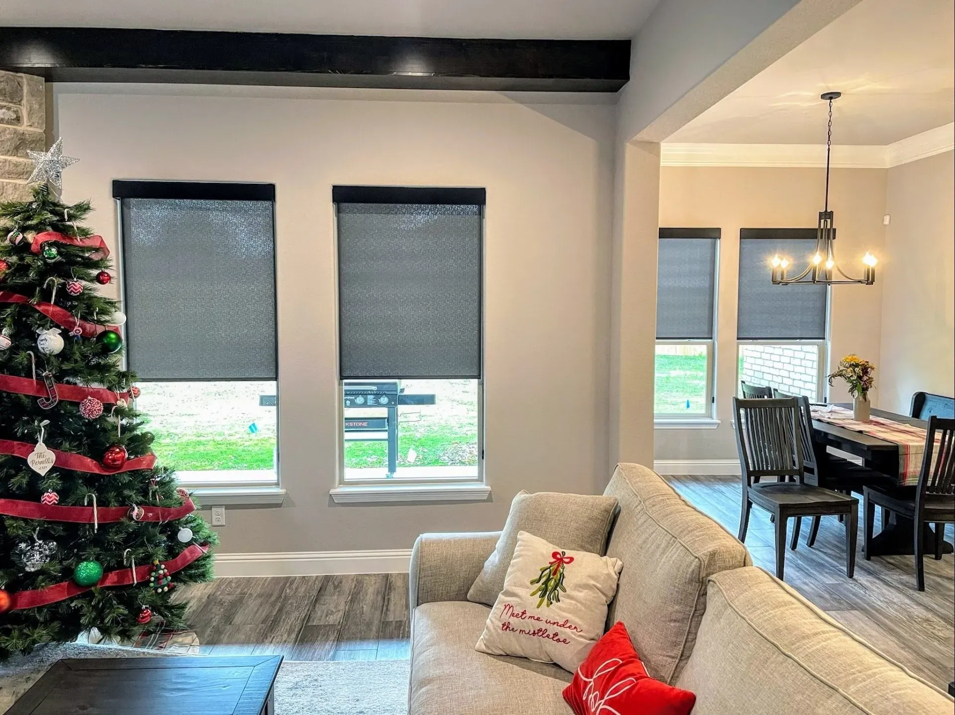 A living room with a couch and a christmas tree Love is Blinds Arizona (844) 936-2446