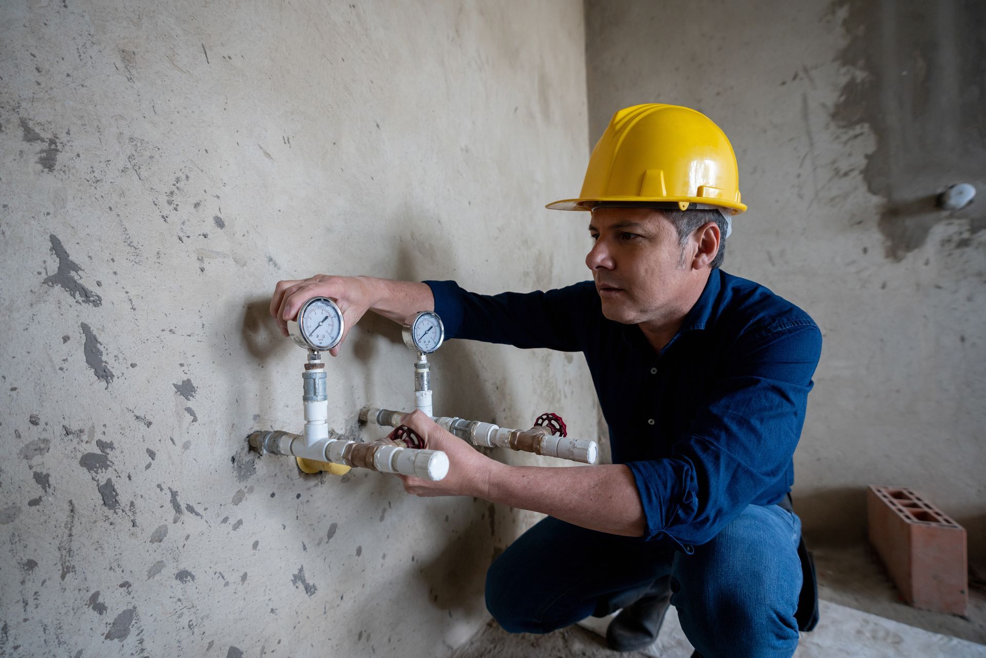 Safety Inspector Supervising the Installation of The Gas Outlets at A Construction Site