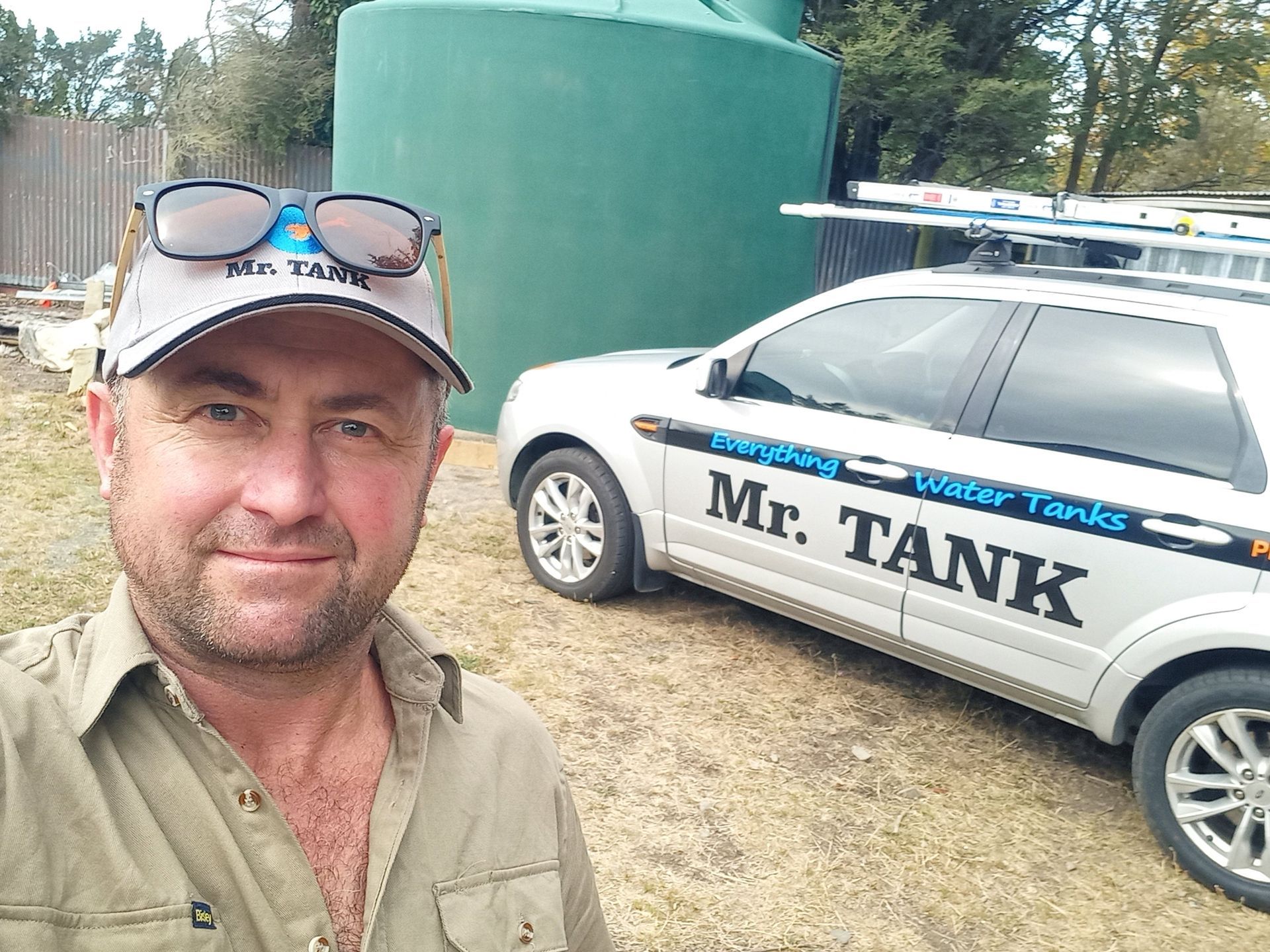 Mr Tank standing beside his work truck