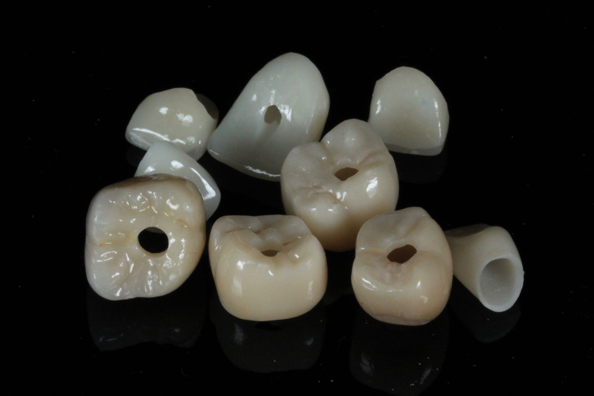 A close up of a dental bridge on a black background.