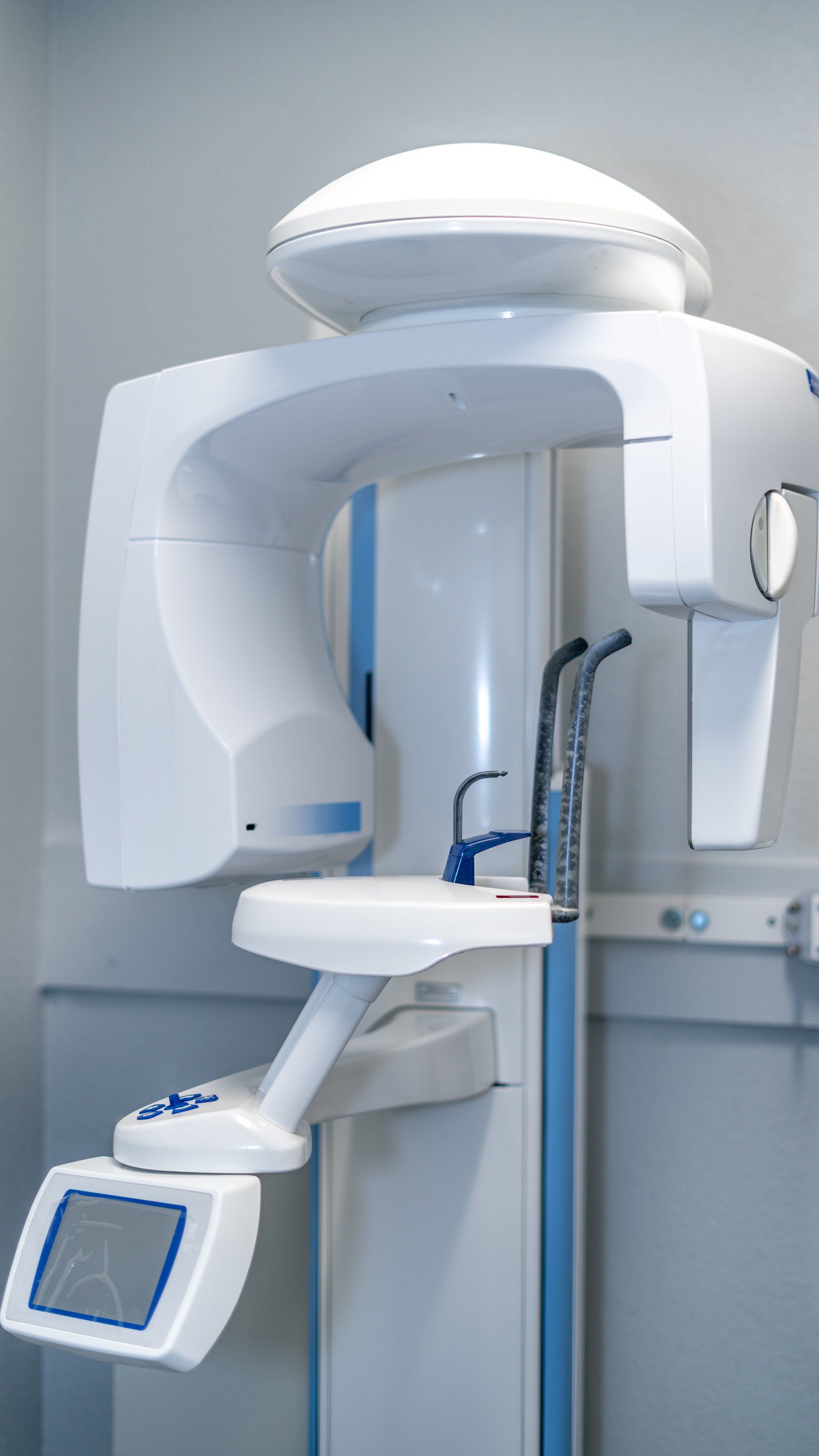 A dental x-ray machine is sitting in a dental office.