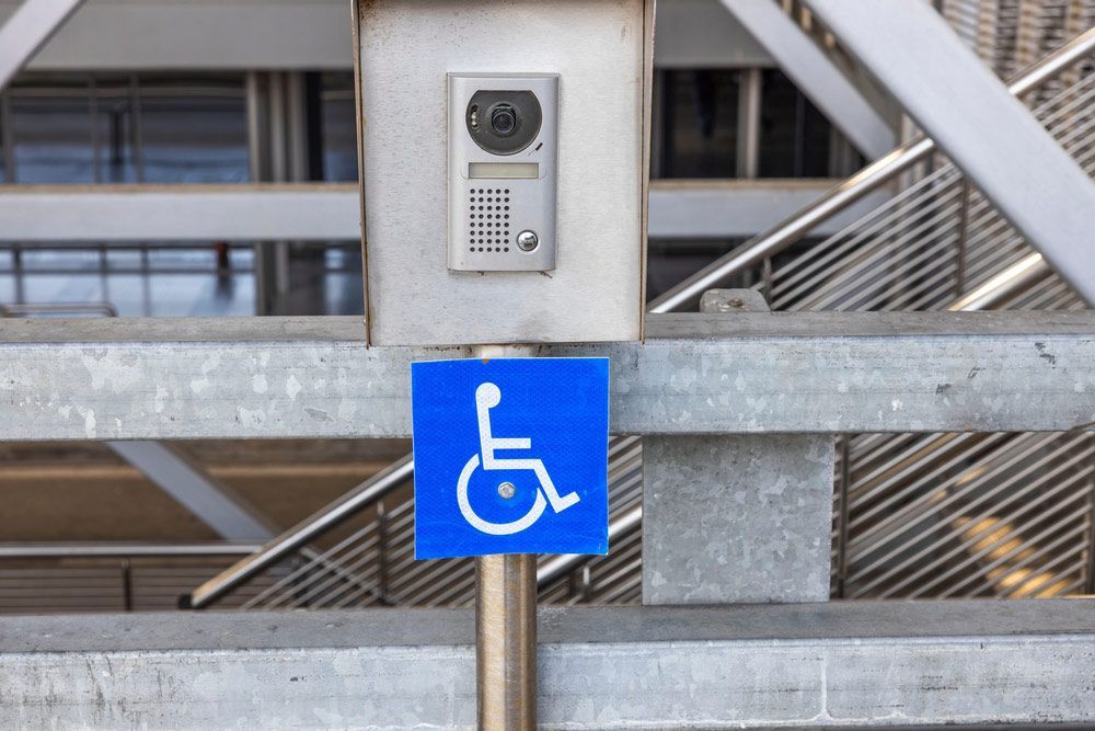 A Blue Sign With A White Wheelchair On It — NQ Health In Bayview Heights, QLD