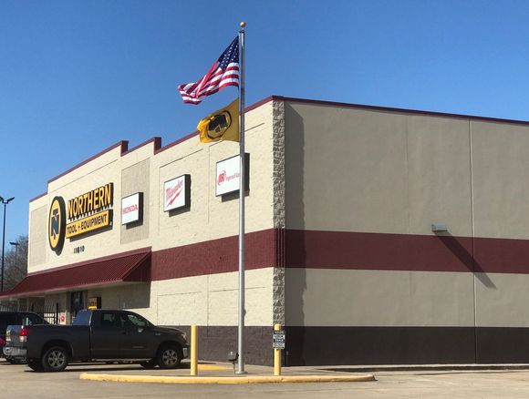 A truck is parked in front of a tobacco store