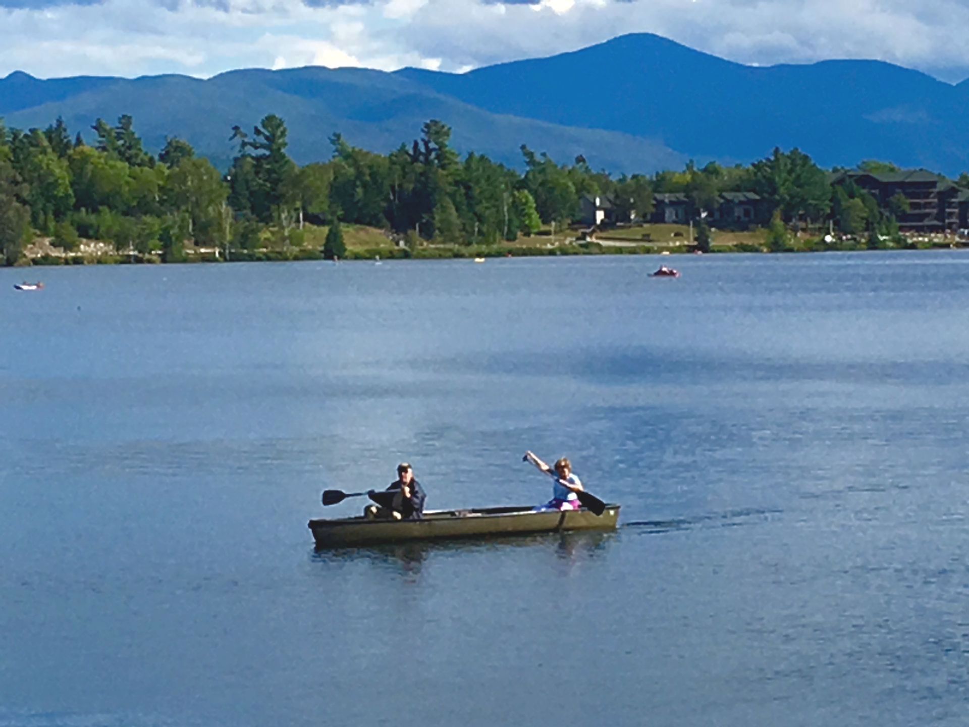 Mirror Lake People paddling in a canoe on Mirror Lake in Lake Placid, NY