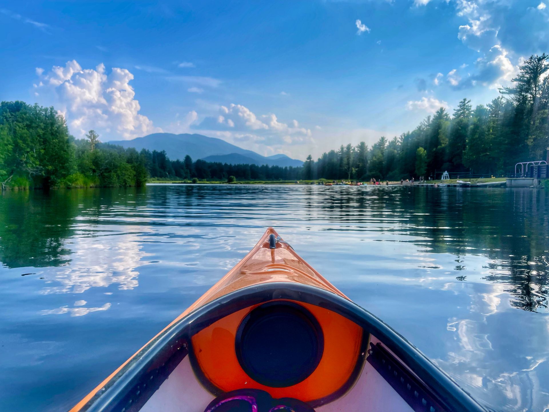 View of lake and distant mountains from a kayak in Lake Everest, Wilmington, NY