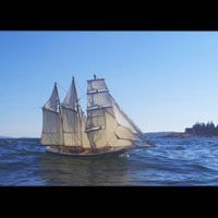 a model sailboat is floating on top of a body of water .