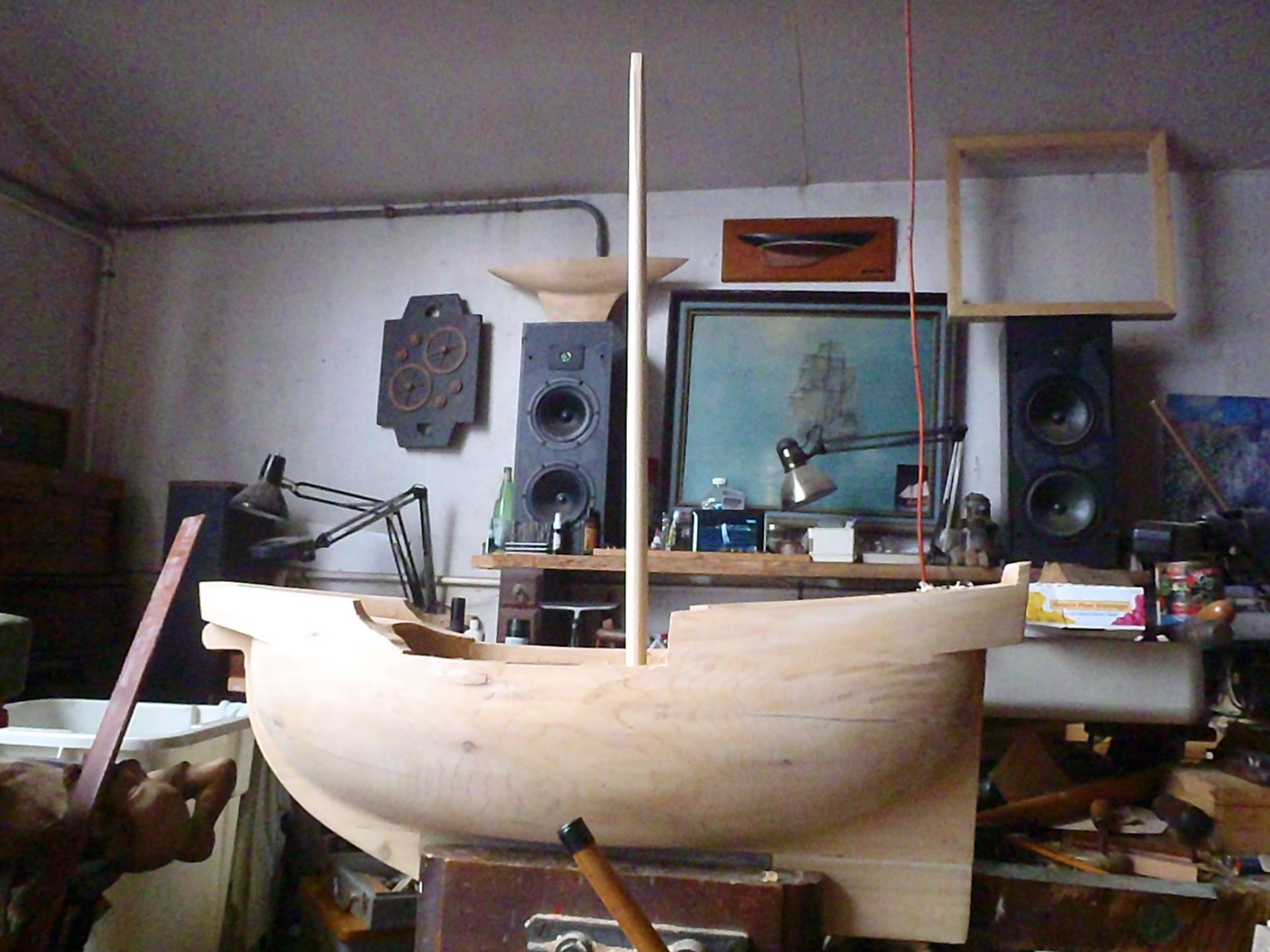 a wooden boat is being built in a room with speakers