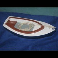 a model boat is sitting on top of a blue blanket .