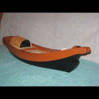 a wooden boat is sitting on top of a blue table .