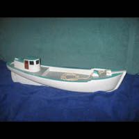 a small white boat is sitting on top of a blue table .