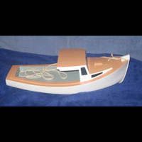 a small wooden boat is sitting on top of a blue surface .