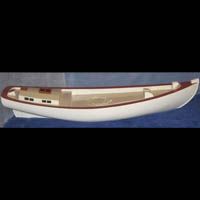 a small white boat is sitting on top of a blue table .