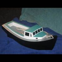 a small boat is sitting on top of a blue blanket .