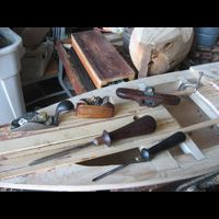 a table topped with a variety of woodworking tools .