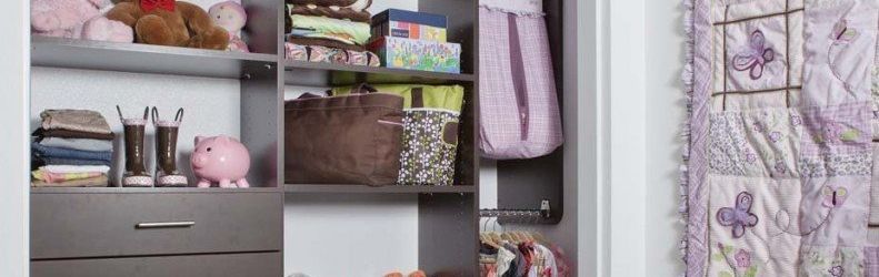 A closet filled with lots of clothes and a pink piggy bank.