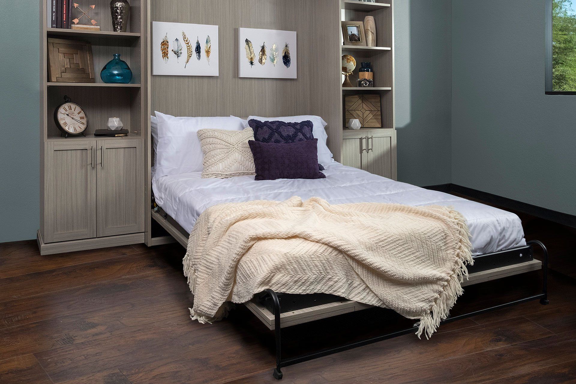 a custom murphy bed system and shelving that is open with the bed down