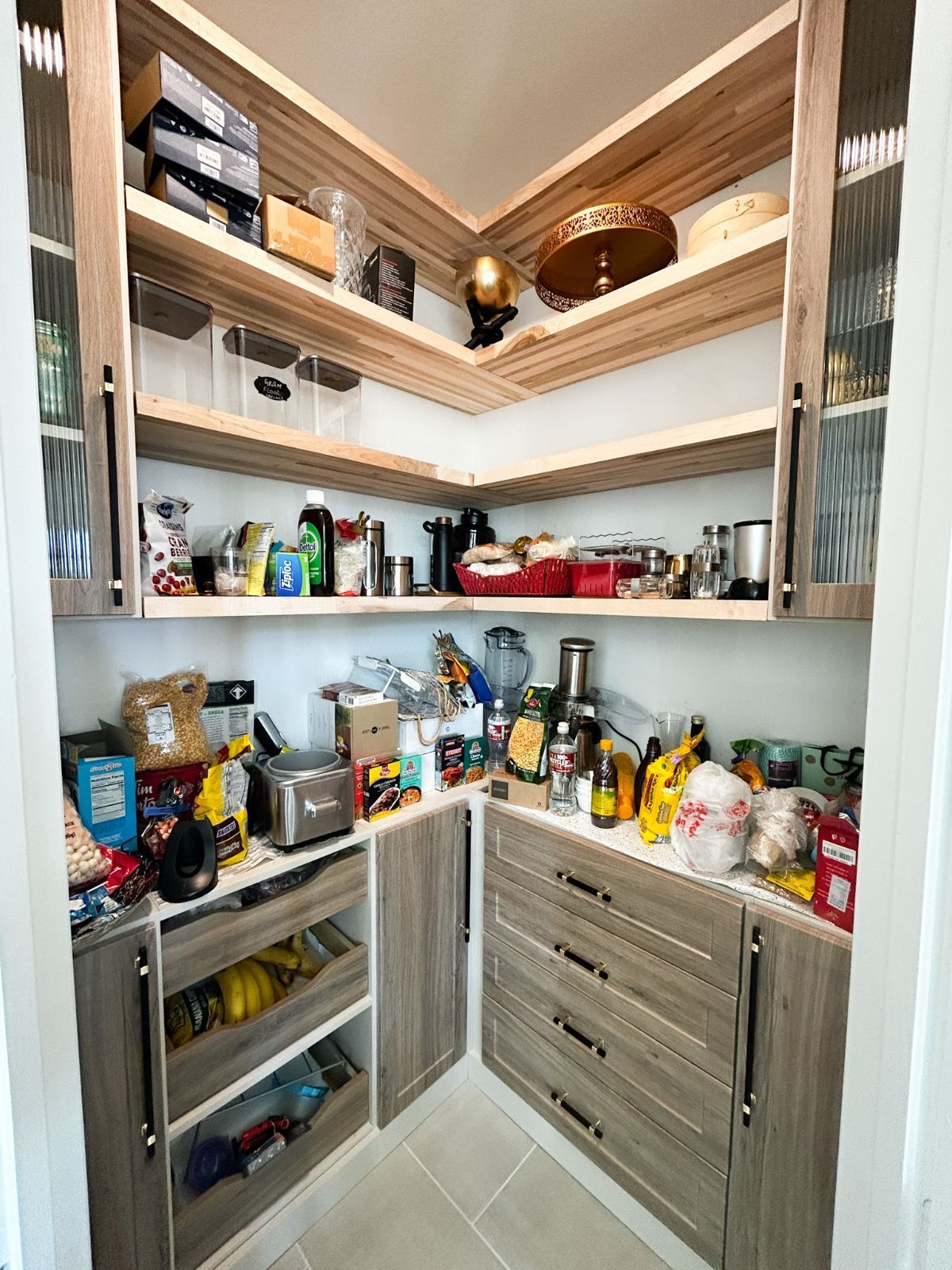 A pantry filled with lots of food and appliances.