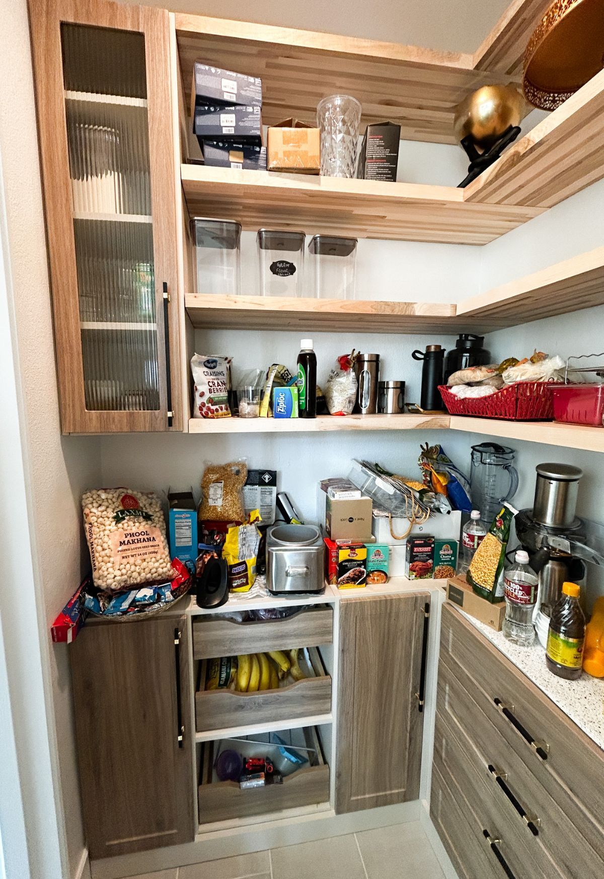 A pantry filled with lots of food and appliances.
