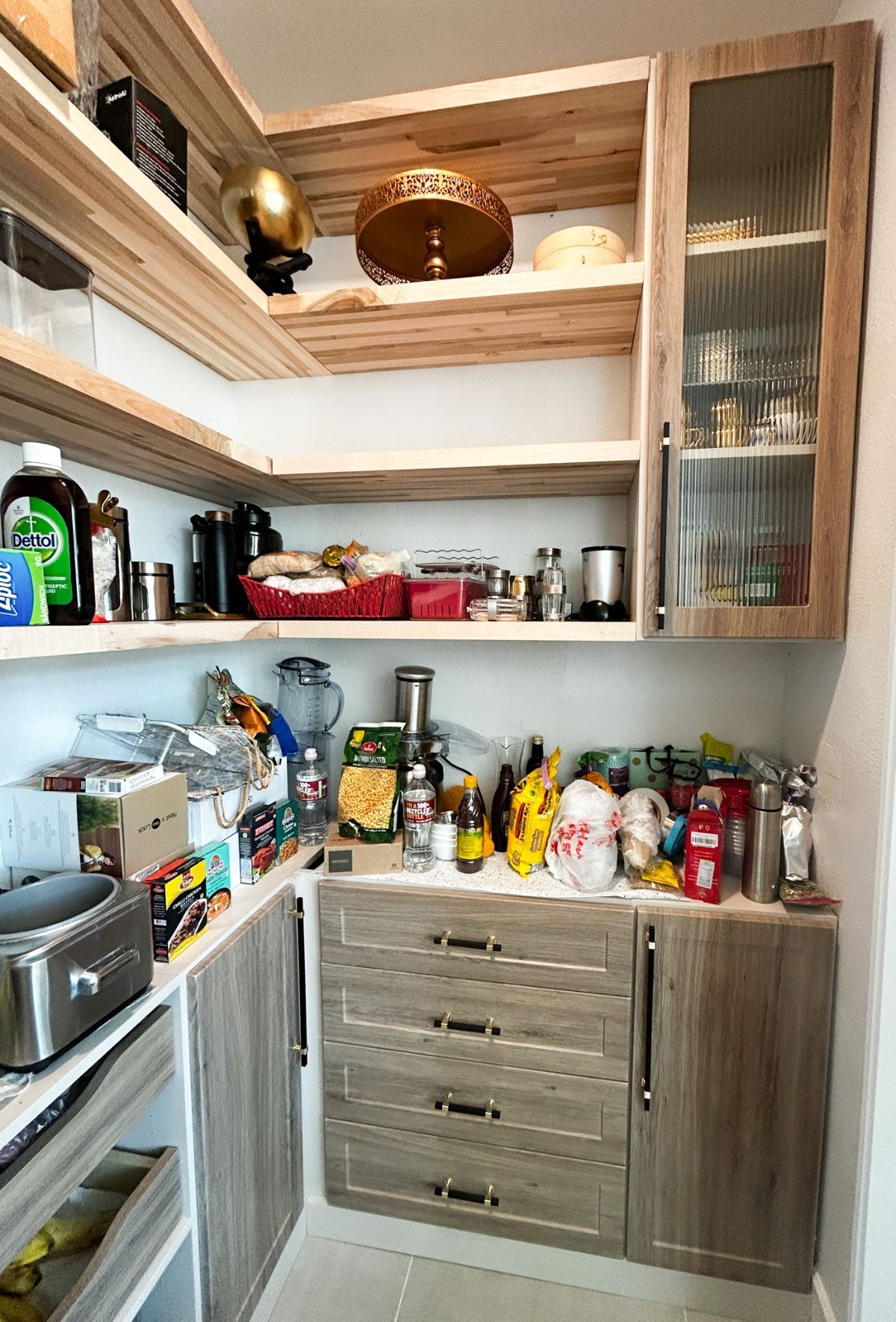 A kitchen pantry filled with lots of food and appliances.
