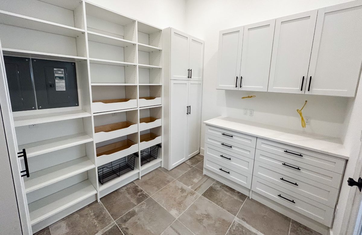 A room with lots of shelves and drawers in it.