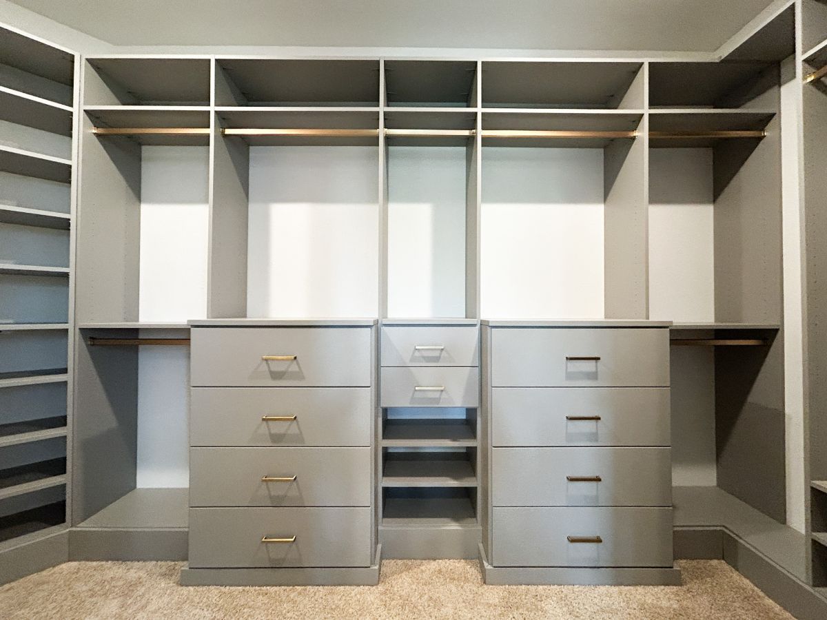 A walk in closet with lots of drawers and shelves.
