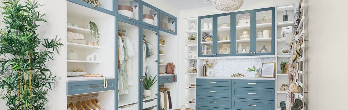 Custom lagoon and White finish walk-in closet filled with clothes and accessories