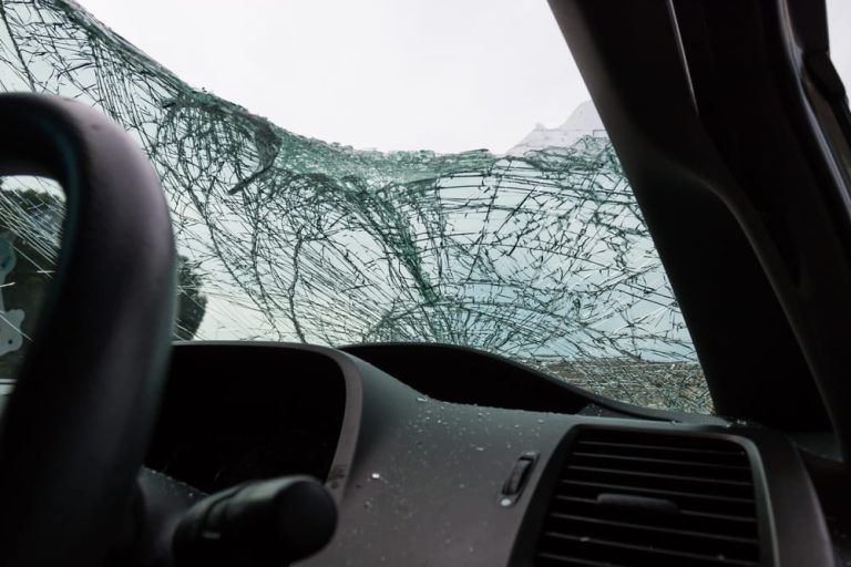 The inside of a car with a broken windshield