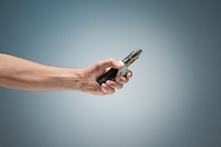 A person is holding a remote control in their hand.