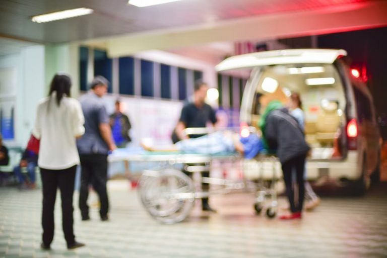 A blurry picture of a person being loaded into an ambulance.