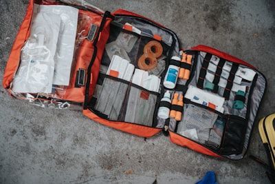 A first aid kit is open and filled with lots of supplies.