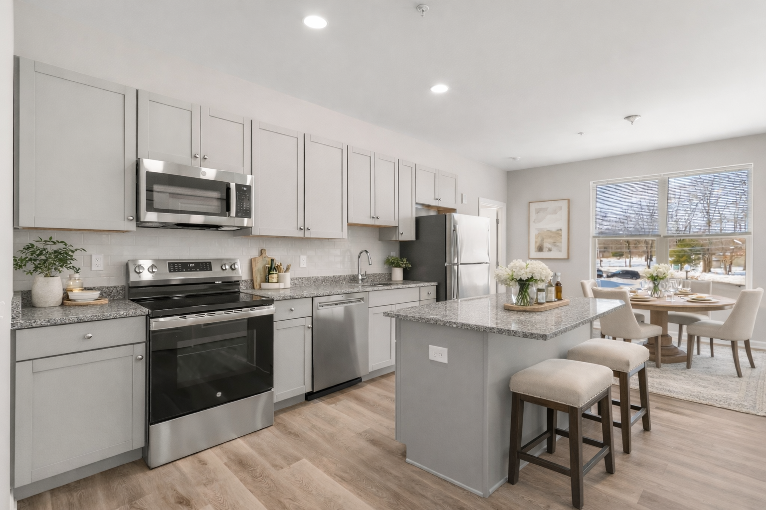 Rainy day kitchen refresh Bright modern apartment kitchen with spring décor and a rainy day view through the window creating a fresh, updated space