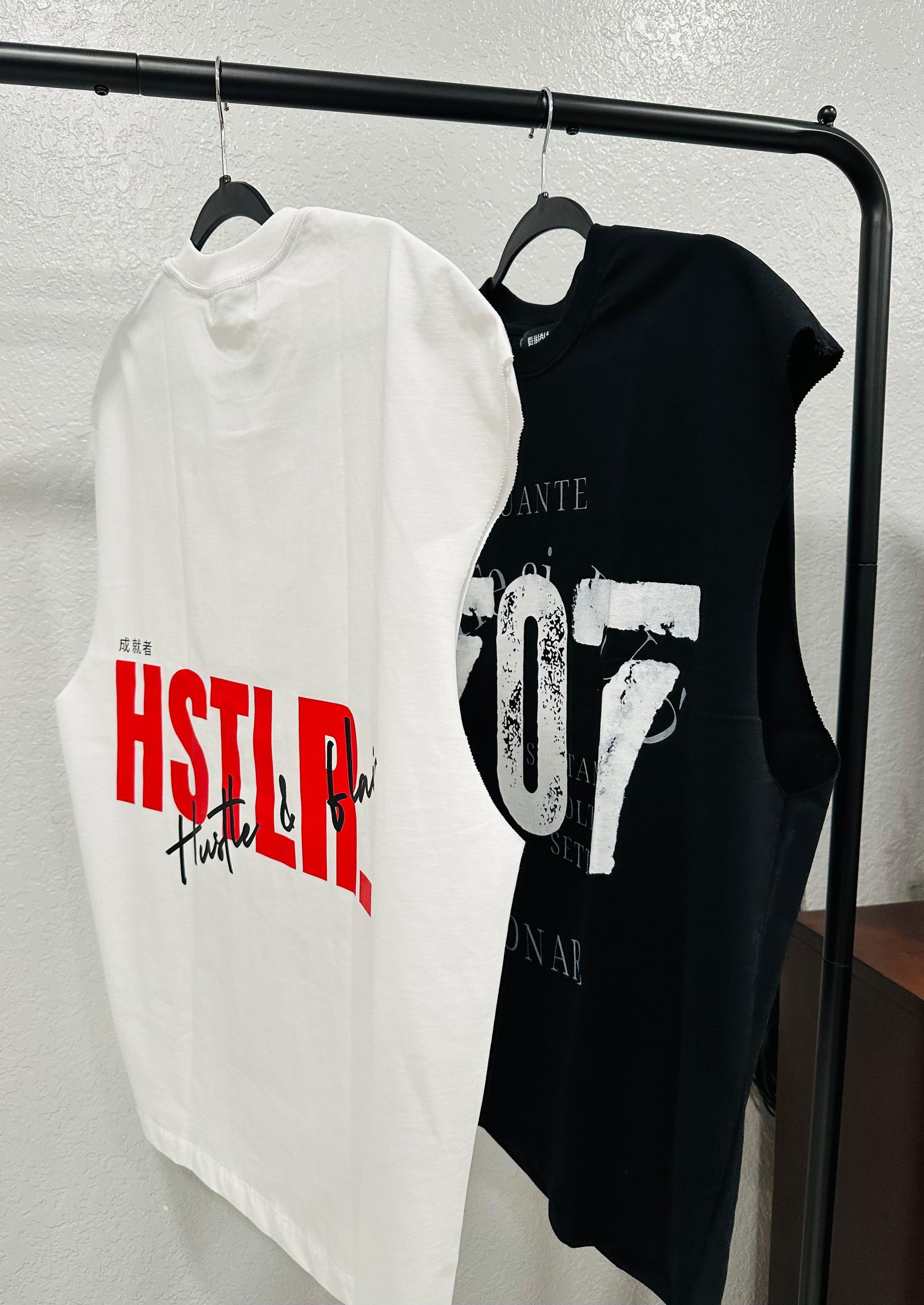 Two sleeveless t-shirts: white with red 