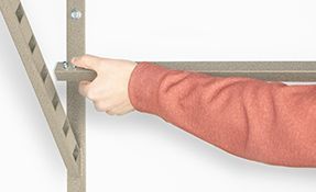 a person is holding a metal shelving in their hand .