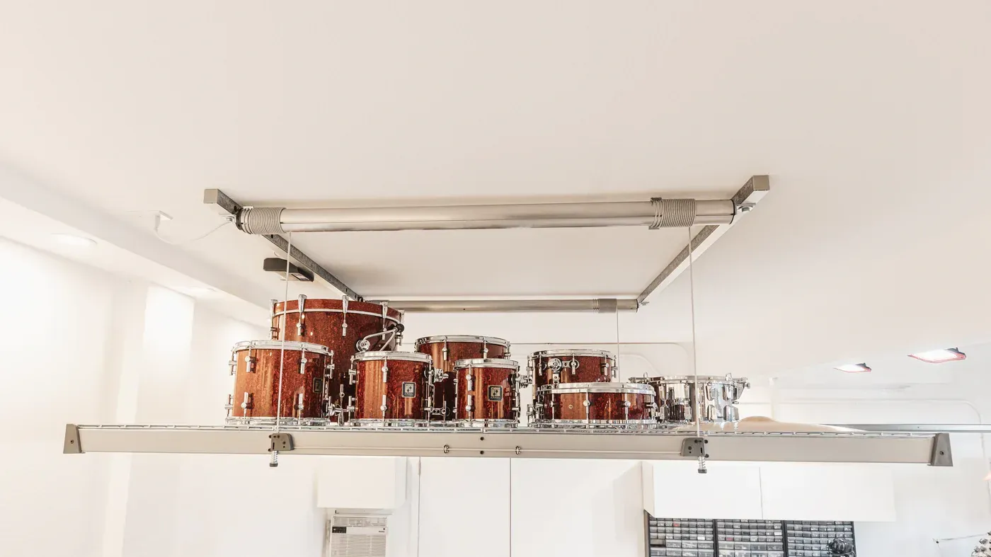 a drum set is hanging from the ceiling of a room .