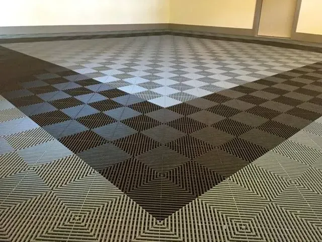 a black and white tile floor in a garage .